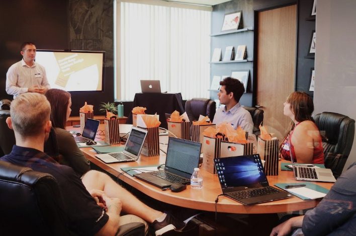 A team in an office discussing resource utilization during a meeting